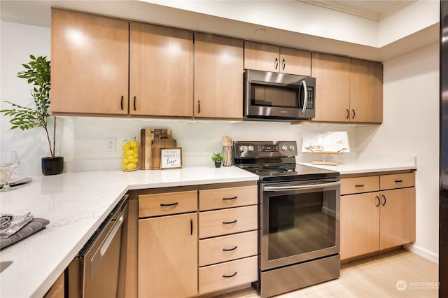 kitchen featuring light wood-type flooring, stainless steel appliances, and light brown cabinets