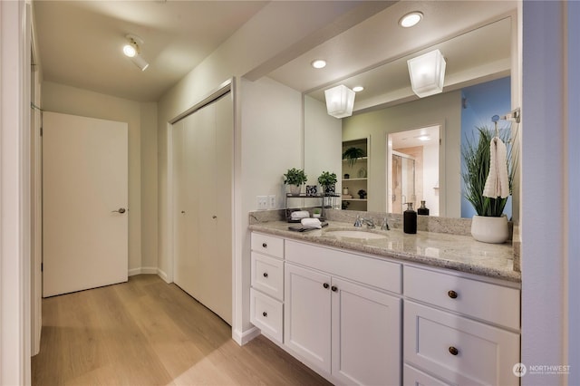 bathroom with vanity and hardwood / wood-style flooring