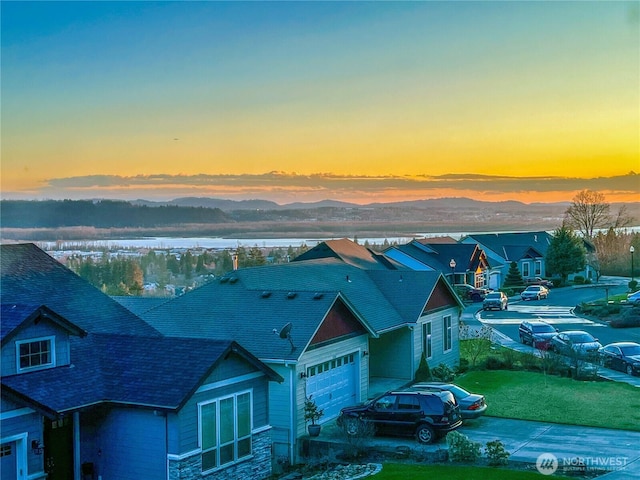 aerial view at dusk featuring a mountain view