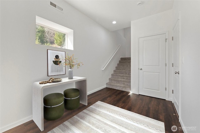 staircase with visible vents, recessed lighting, baseboards, and wood finished floors