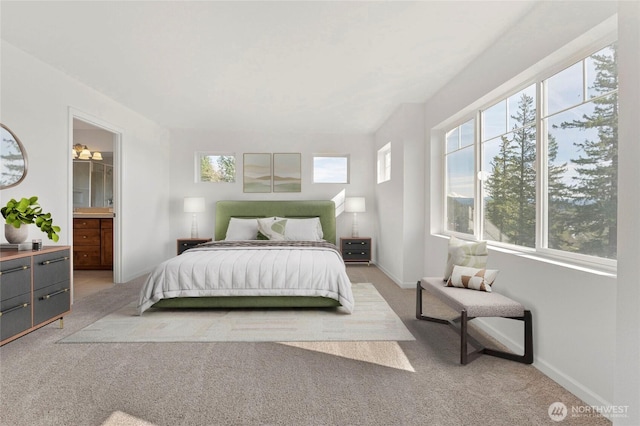 bedroom with multiple windows, light carpet, and baseboards