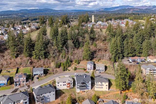 aerial view featuring a mountain view, a residential view, and a view of trees