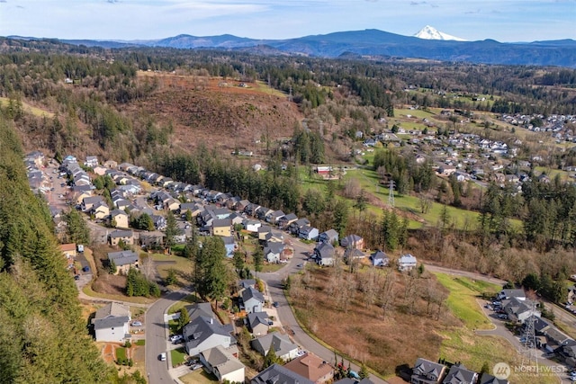 bird's eye view with a residential view, a mountain view, and a view of trees