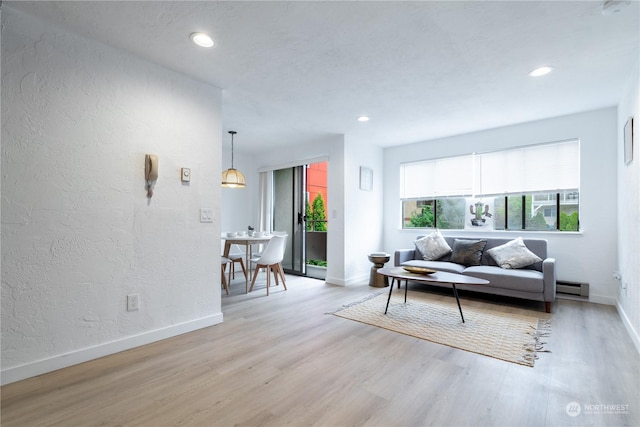 living room featuring light wood-type flooring and a baseboard radiator