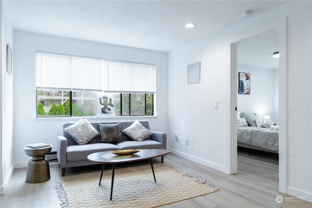 living room featuring baseboard heating and light wood-type flooring