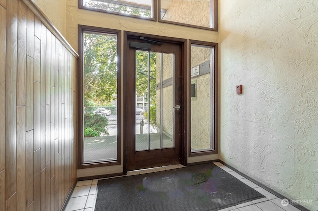 doorway to outside with light tile patterned flooring