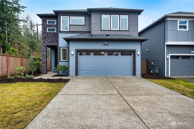 view of front of house featuring a front yard and a garage