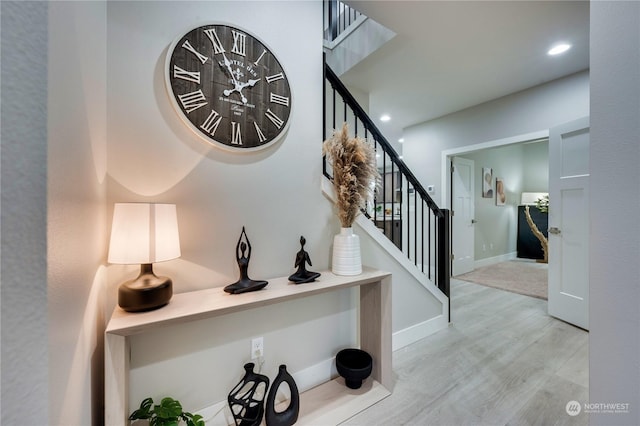 stairway with hardwood / wood-style flooring