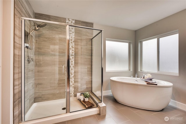 bathroom featuring plus walk in shower and tile patterned floors