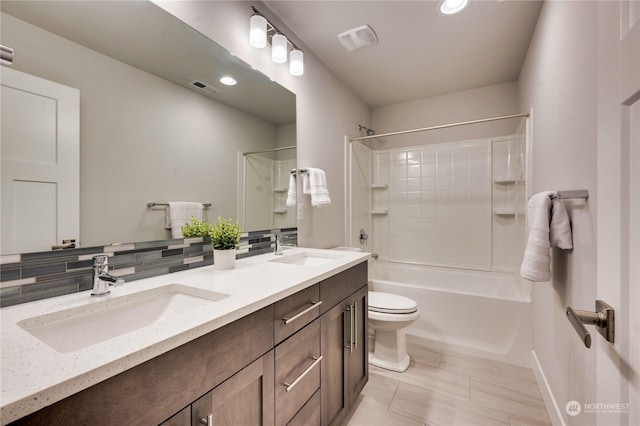 full bathroom featuring toilet, vanity, tasteful backsplash, and  shower combination