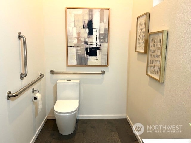 bathroom with toilet and hardwood / wood-style flooring