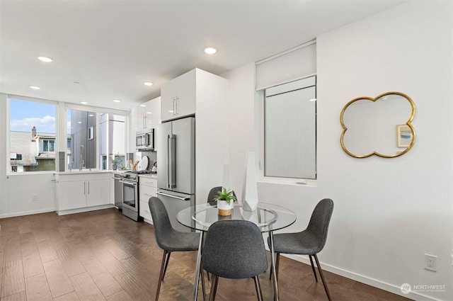 dining area with dark hardwood / wood-style flooring