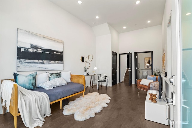 interior space featuring a towering ceiling and dark hardwood / wood-style floors