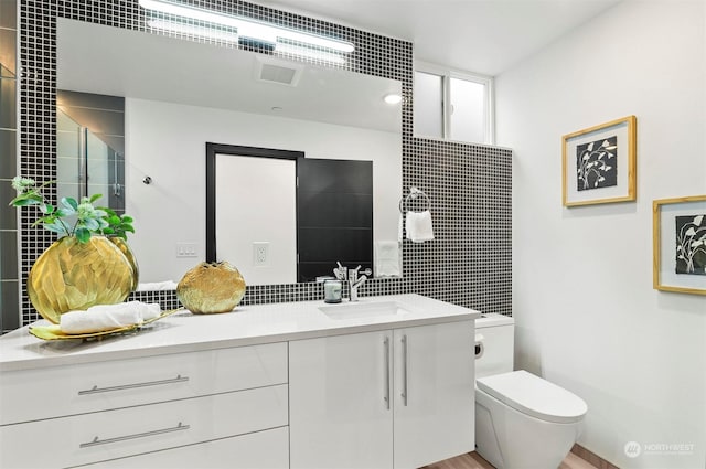 bathroom with toilet and vanity