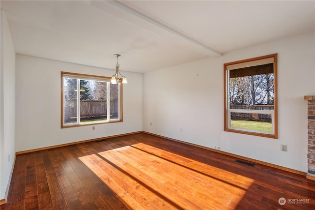 unfurnished dining area with hardwood / wood-style floors, a chandelier, and a healthy amount of sunlight