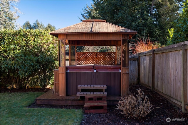 deck with a gazebo and a hot tub