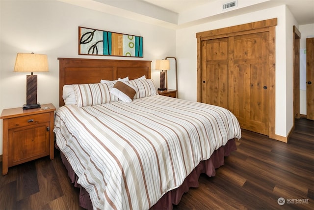 bedroom with dark hardwood / wood-style floors