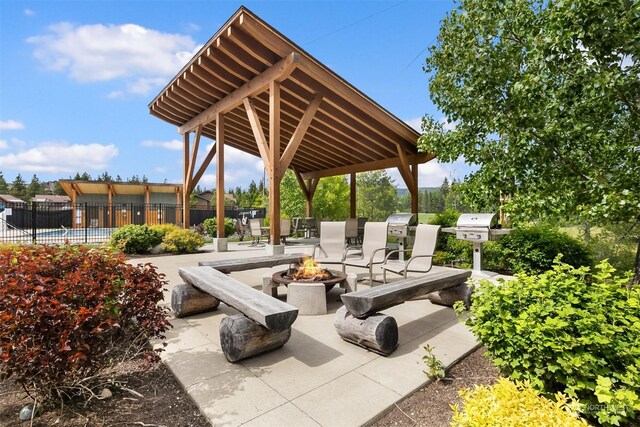 view of patio / terrace with a gazebo, a grill, and an outdoor fire pit