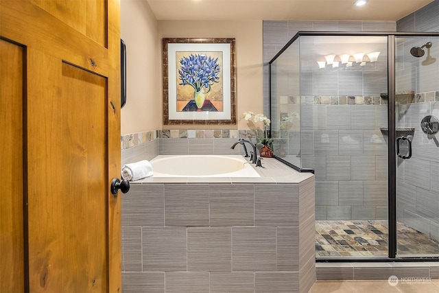 bathroom with separate shower and tub and tile patterned flooring