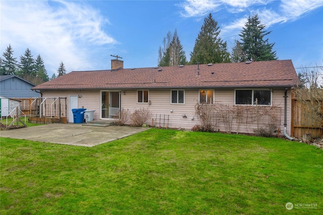 rear view of property featuring a lawn and a patio