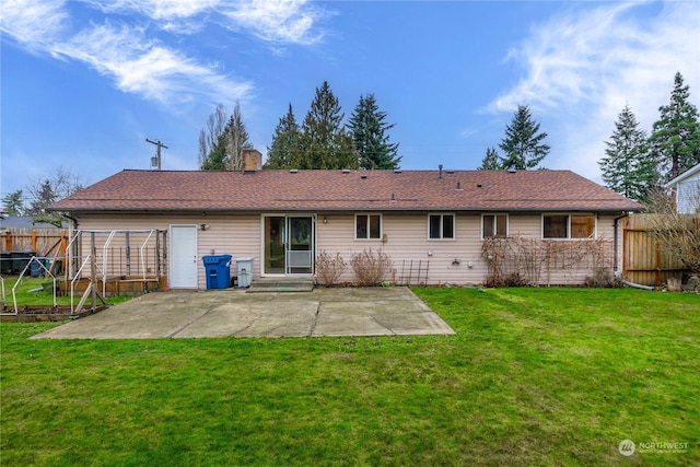 back of property with a patio area and a yard