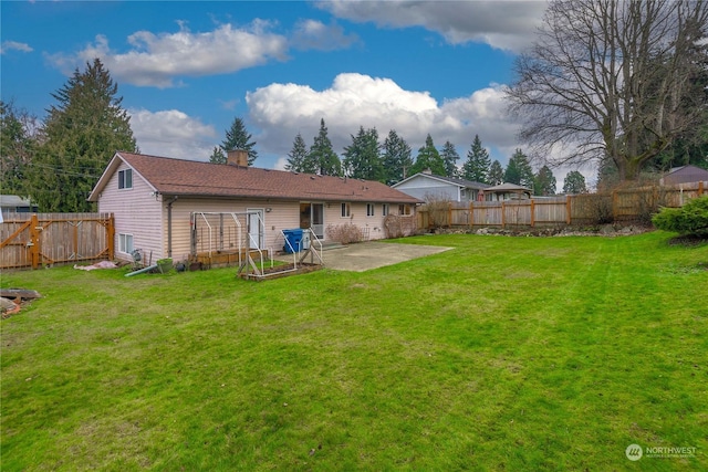 rear view of house featuring a patio area and a lawn