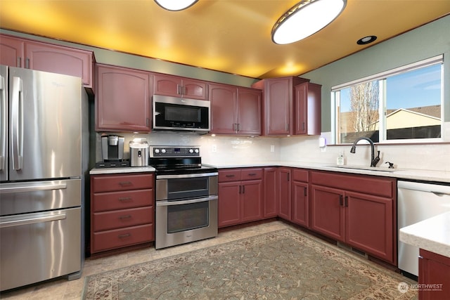 kitchen with stainless steel appliances, sink, and backsplash