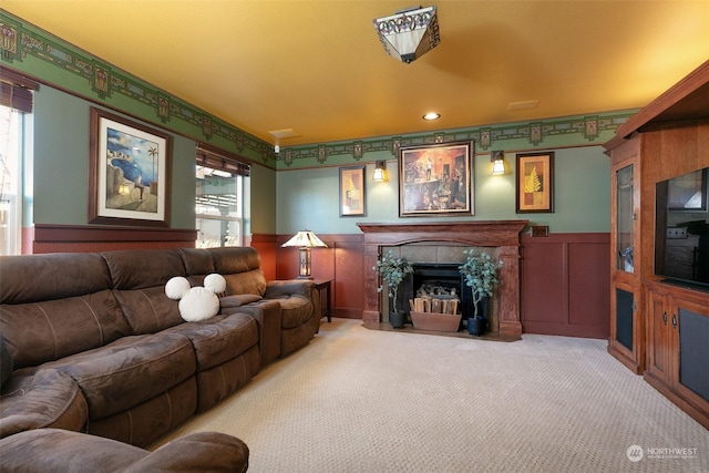 living room with a tiled fireplace and light carpet