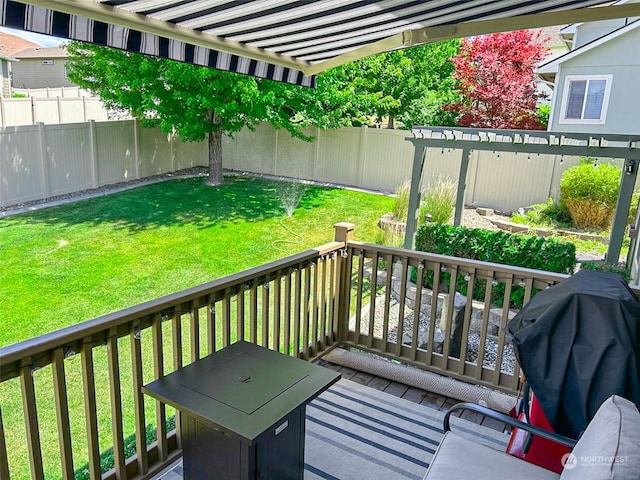 deck featuring grilling area and a lawn