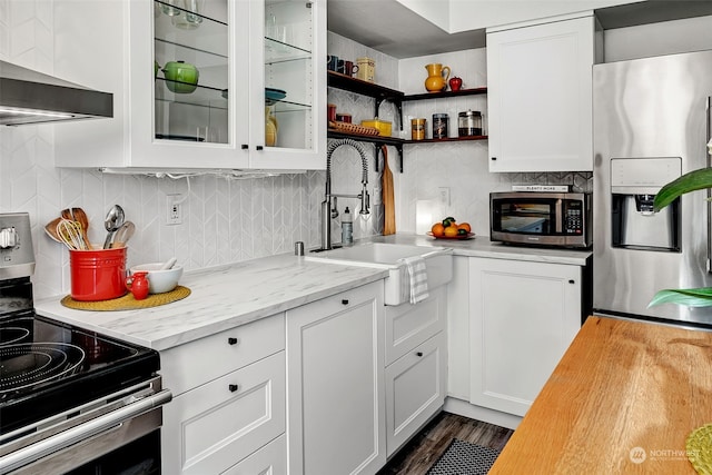 kitchen featuring white cabinets, appliances with stainless steel finishes, backsplash, and sink