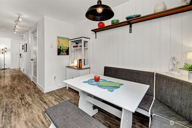 dining space with dark hardwood / wood-style flooring