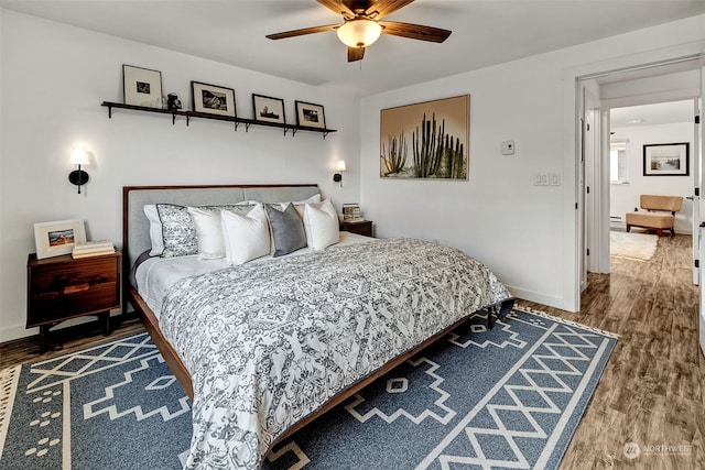 bedroom with ceiling fan and wood-type flooring