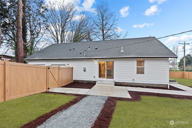 rear view of house featuring a patio and a yard