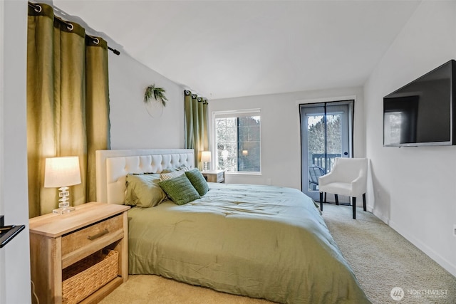 bedroom with vaulted ceiling, carpet flooring, and baseboards