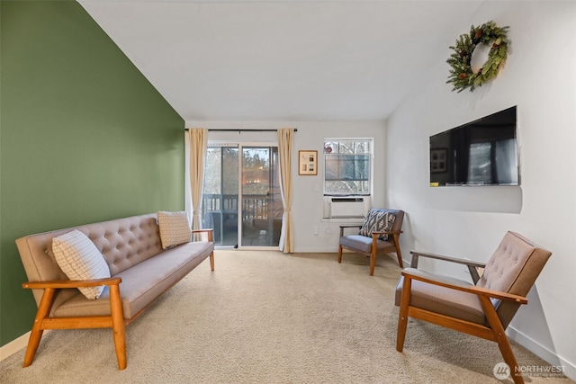 sitting room featuring lofted ceiling, carpet flooring, and baseboards