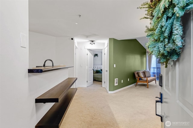 interior space featuring attic access, light carpet, and baseboards