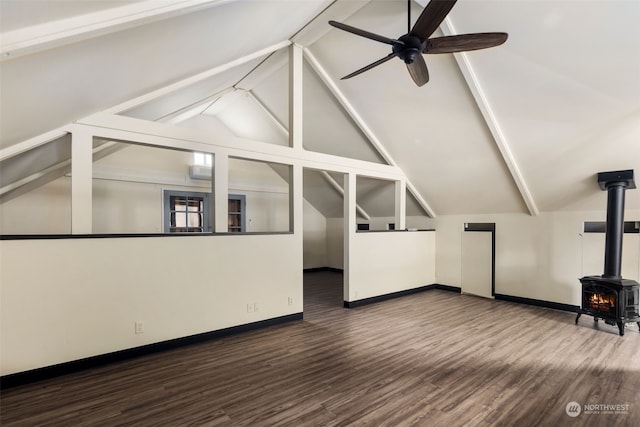 unfurnished living room with dark wood-type flooring, ceiling fan, vaulted ceiling, and a wood stove