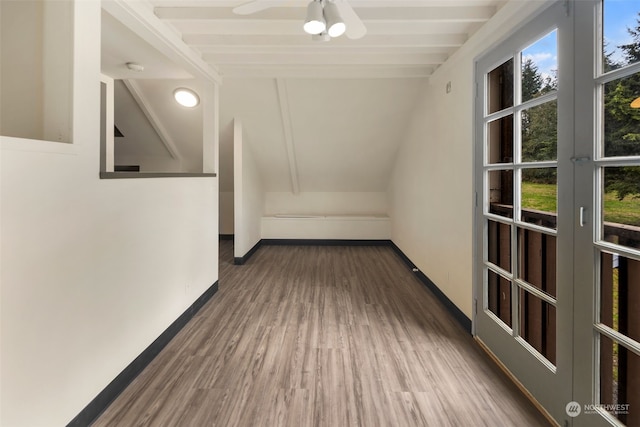 hallway featuring beamed ceiling and dark wood-type flooring