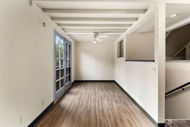 empty room featuring ceiling fan, hardwood / wood-style floors, and beam ceiling