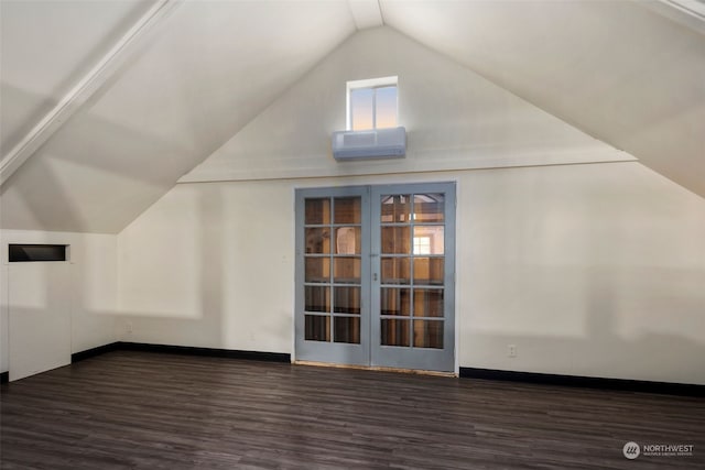 bonus room with dark wood-type flooring, french doors, lofted ceiling, and a wall unit AC