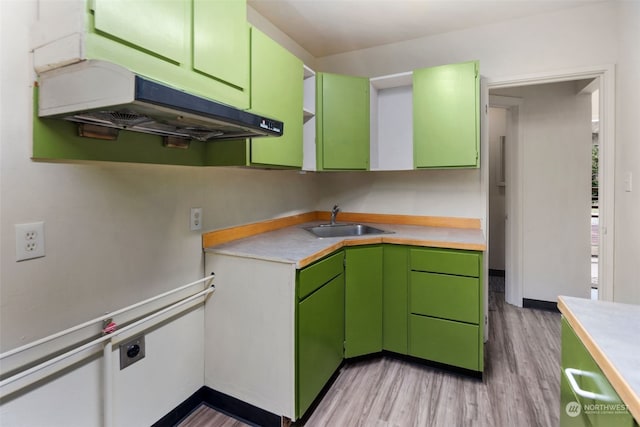 kitchen featuring sink, green cabinets, and light hardwood / wood-style floors