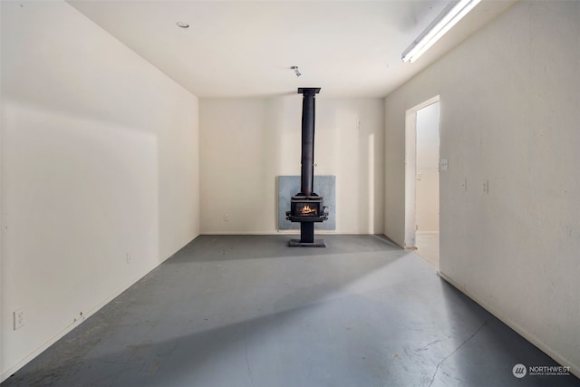 unfurnished living room featuring a wood stove