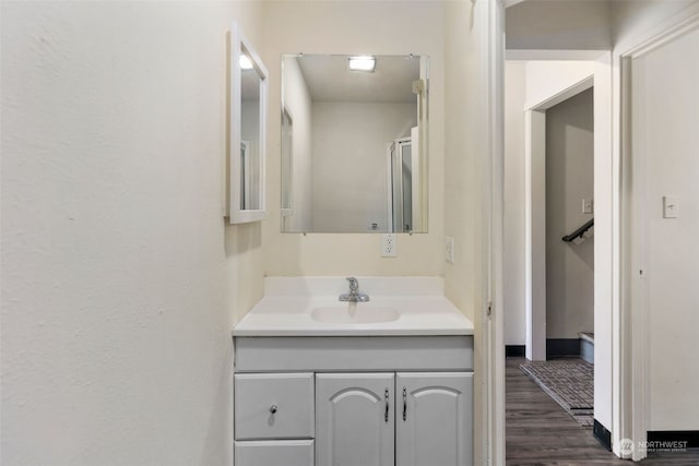 bathroom with hardwood / wood-style floors and vanity