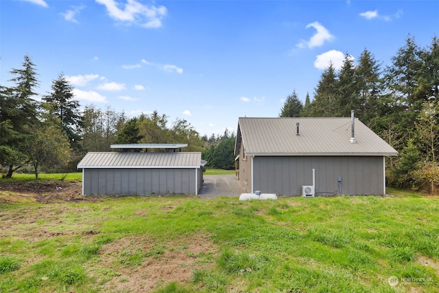 view of property exterior with a yard and an outdoor structure