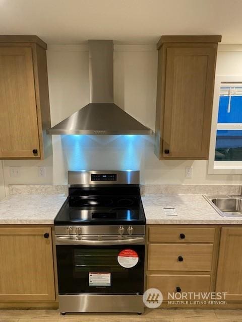 kitchen with sink, electric stove, and wall chimney range hood