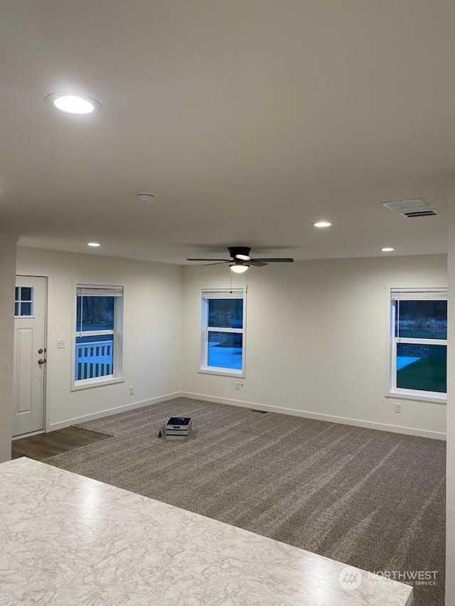 carpeted empty room featuring ceiling fan