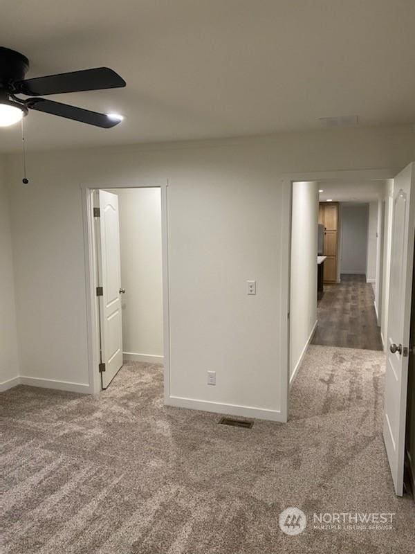 carpeted empty room featuring ceiling fan