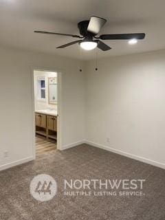 unfurnished bedroom with connected bathroom and ceiling fan