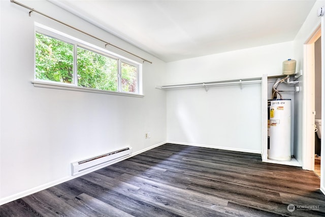 unfurnished bedroom featuring water heater, baseboard heating, and dark wood-type flooring