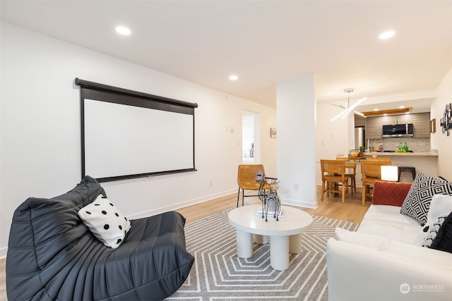 home theater room featuring light wood-type flooring